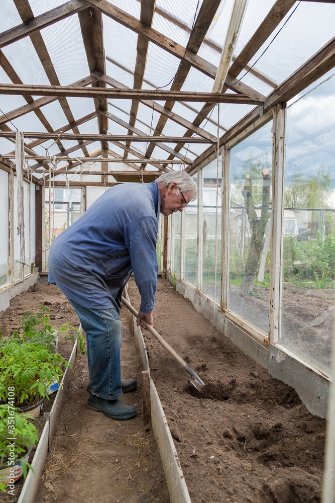 Cheerful senior Elderly man digging garden spring time Cheerful senior Elderly man digging garden spring time