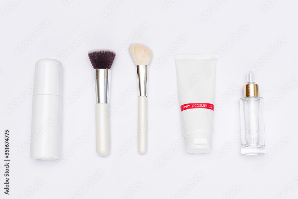 Concept of makeup. Makeup brushes and cosmetics needed for skin care, white background, top view, copy space Concept of makeup. Makeup brushes and cosmetics needed for skin care, white background, top view, copy space