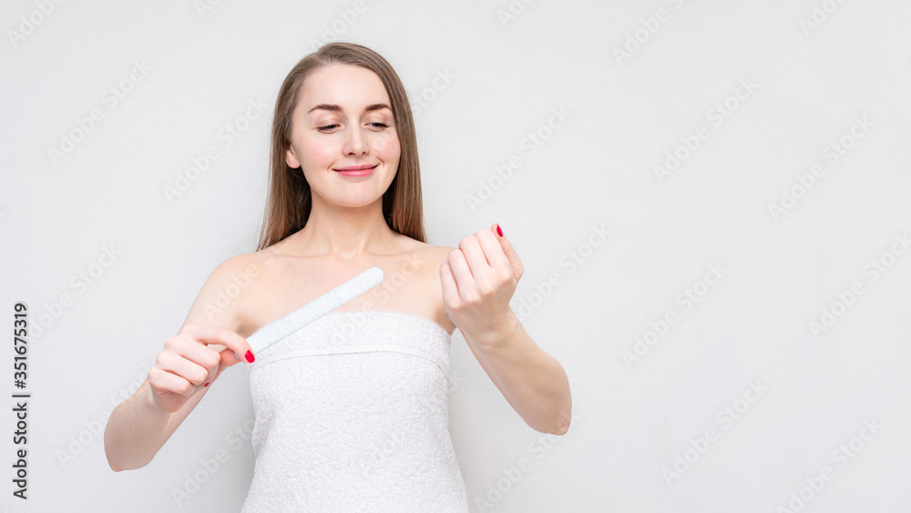 Pretty girl nail sawing with nail file, portrait, white background, copy space, 16:9 Pretty girl nail sawing with nail file, portrait, white background, copy space, 16:9