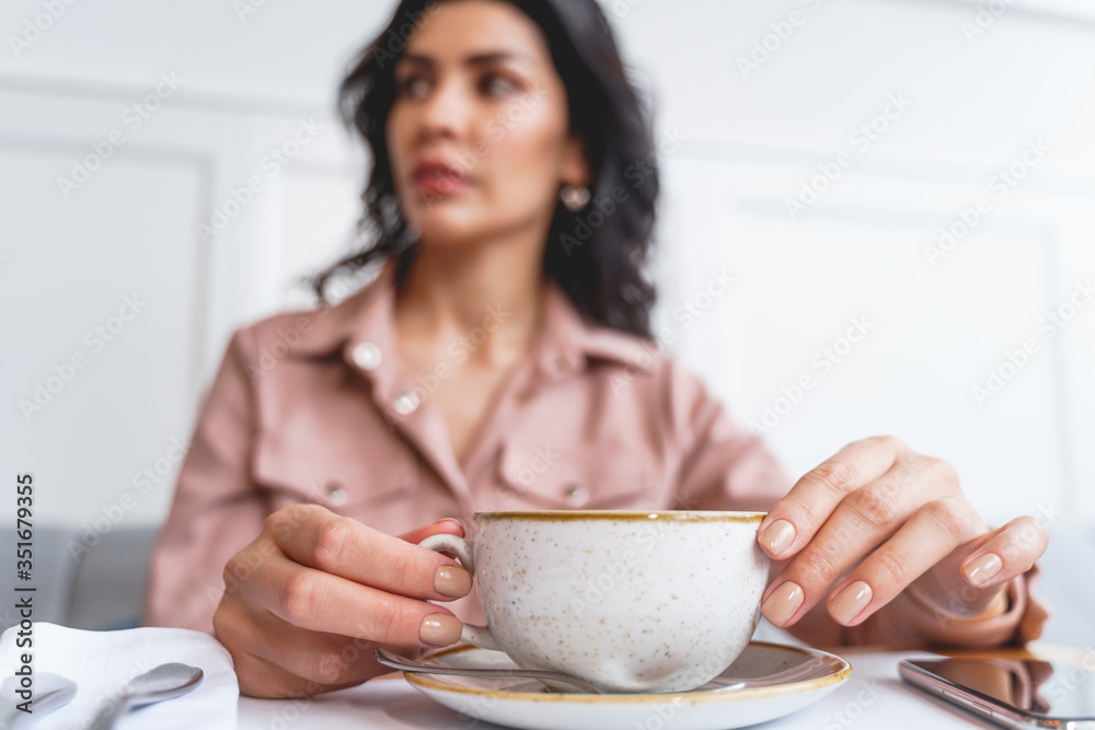 Charming young lady drinking coffee in cafe Charming young lady drinking coffee in cafe