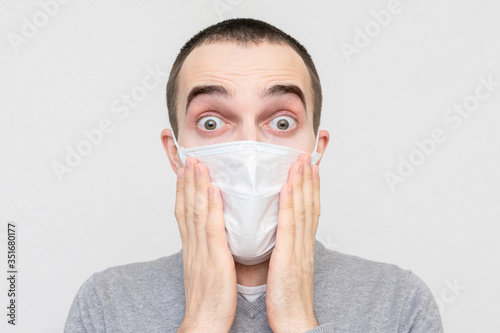 Afraid man with a medical mask to avoid infection with coronavirus, portrait, close-up
