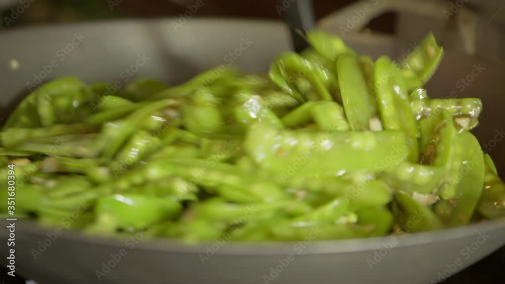 Close-up of person preparing fresh green peas in cooking utensil - Chiang Rai, Thailand Close-up of person preparing fresh green peas in cooking utensil - Chiang Rai, Thailand