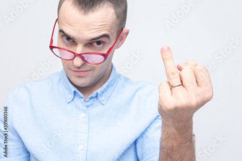 Man hints that he is married and shows off his wedding ring  focus on hand  white background