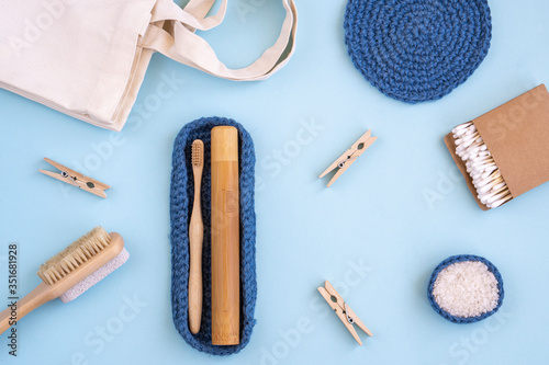 Zero Waste Set For Bathing On A Light Blue Background. Zero Waste Cotton Bag. Natural sisal brush, wooden comb, sea salt, bamboo toothbrush, washcloth and cotton swabs. Top view, flat lay