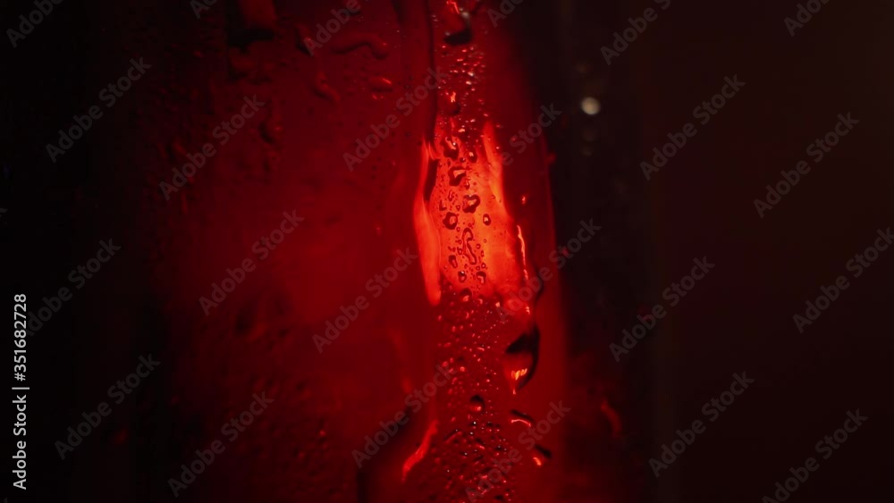beautifully lit by a glass beaker filled with cola.closeup beautifully lit by a glass beaker filled with cola.closeup
