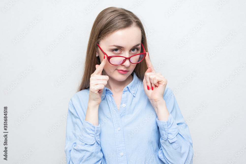 Playful girl took off red glasses, portrait, white background, copy space