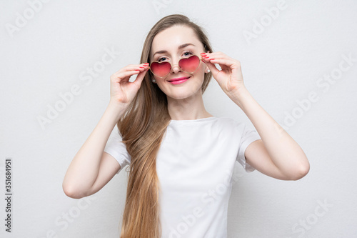 Beautiful girl with heart-shaped glasses  portrait  white background