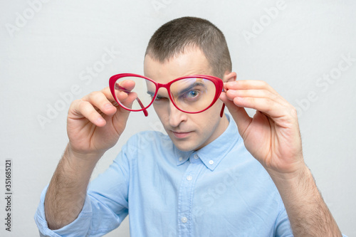 Person takes off his glasses  man has poor eyesight  portrait  white background