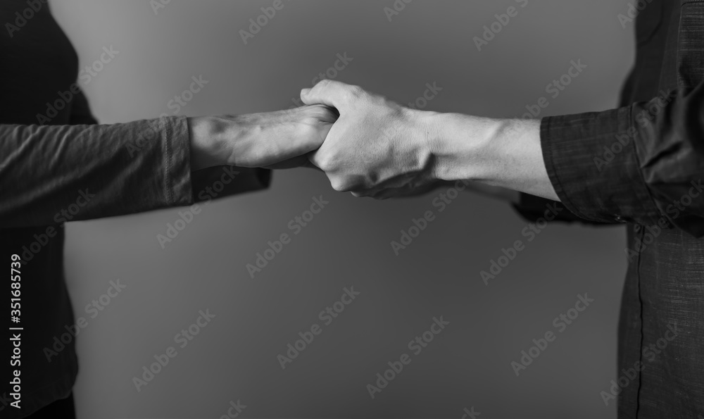 Obraz premium Closeup of two hands holding each other 