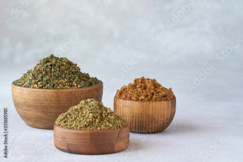 Mixed spice zaatar or zatar in wooden bowls, Various type of zaatar blend. Close up with copy space photo