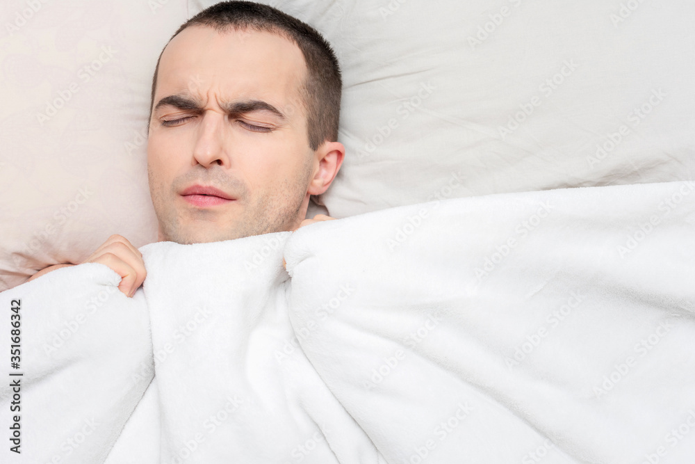 Person sleeps in his bed, portrait, top view, copy space, 16:9 Person sleeps in his bed, portrait, top view, copy space, 16:9