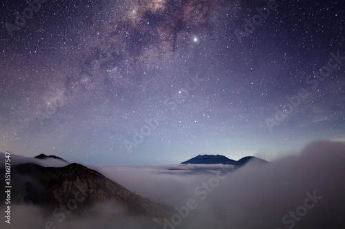 Toxic volcano Ijen on Java island, Indonesia. Night sky full of stars, another planet landscape.