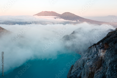 Toxic volcano Ijen on Java island, Indonesia. Foggy sunrise, another planet landscape.
