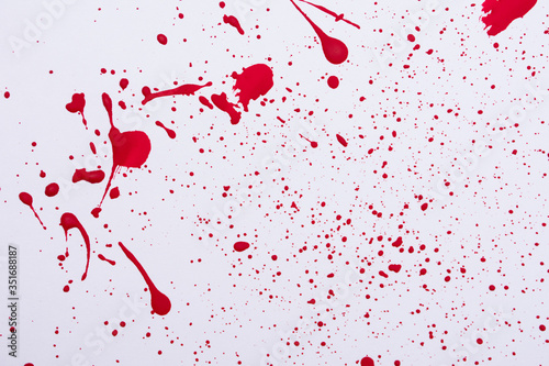 Red paint splashes. Colorful red paint explosion on white background, texture