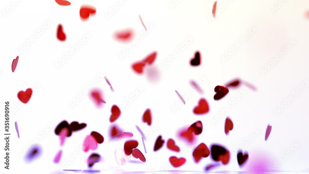 Pink heart confetti falling on the floor