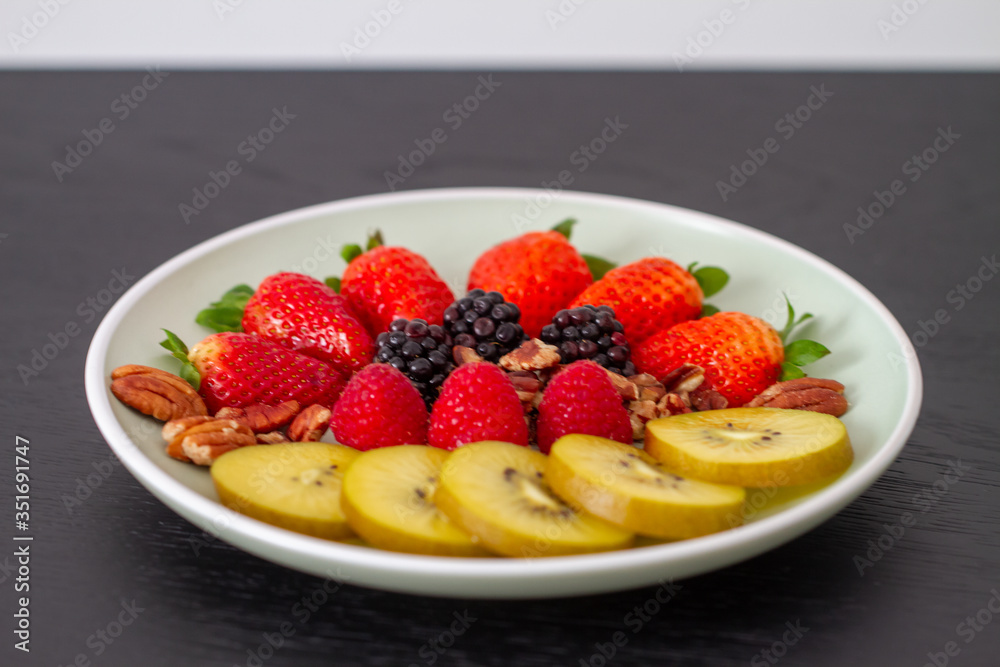 Breakfast plate with fruits and pecan nuts