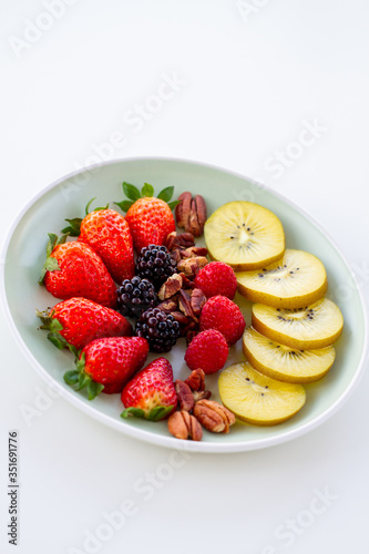 Breakfast plate with fruits and pecan nuts