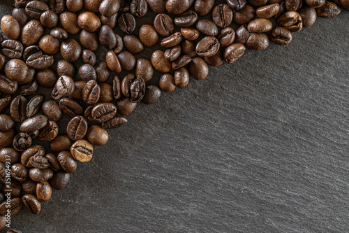 Black coffee background. Caffeine espresso beans for breakfast dark drink in cup. Cafe food. Assorted ground and instant brown roasted coffee seeds on stone. Copy space, top view © Maksym