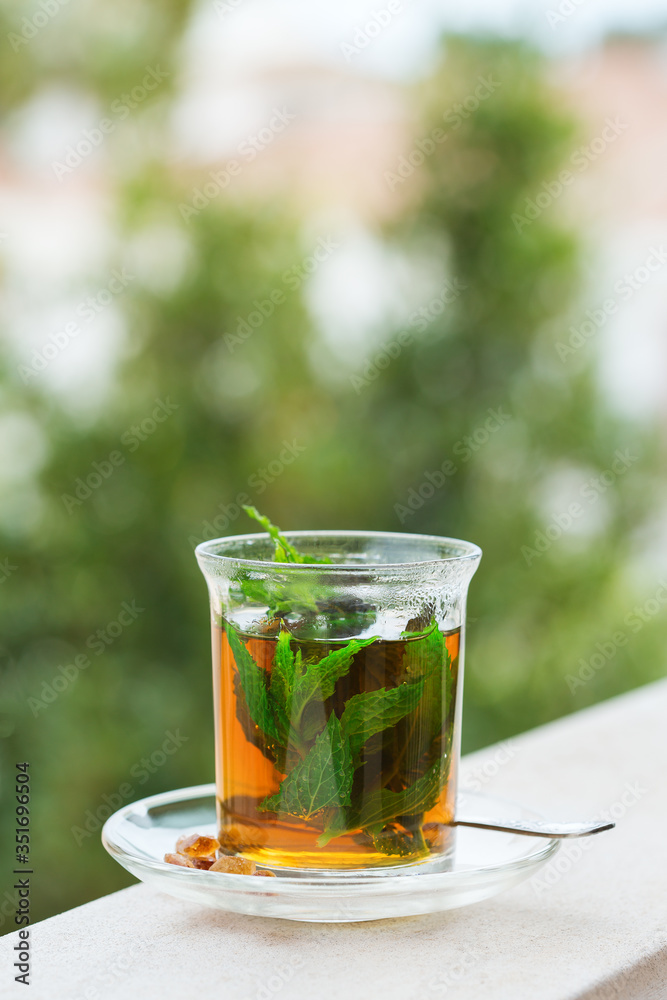 Glass of hot mint tea, traditional moroccan moorish beverage Glass of hot mint tea, traditional moroccan moorish beverage