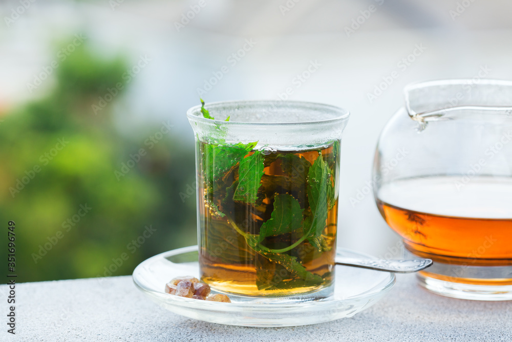 Glass of hot mint tea, traditional moroccan moorish beverage Glass of hot mint tea, traditional moroccan moorish beverage