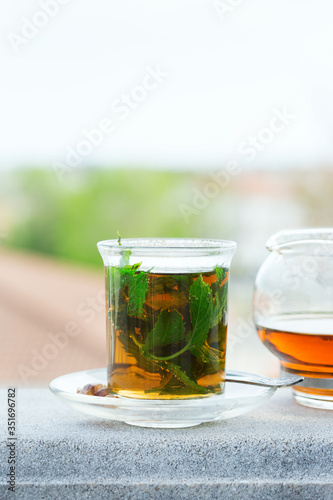 Glass of hot mint tea, traditional moroccan moorish beverage