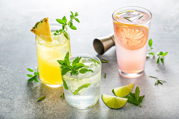 Refreshing summer cocktails on the table with lime, grapefruit and pineapple