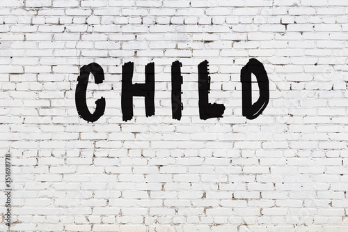 Photos White wall with black paint inscription child on it
