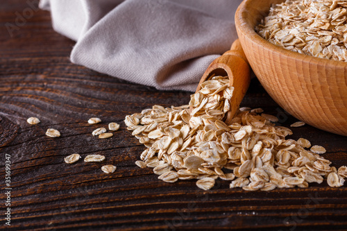 raw oatmeal on a wooden rustic background