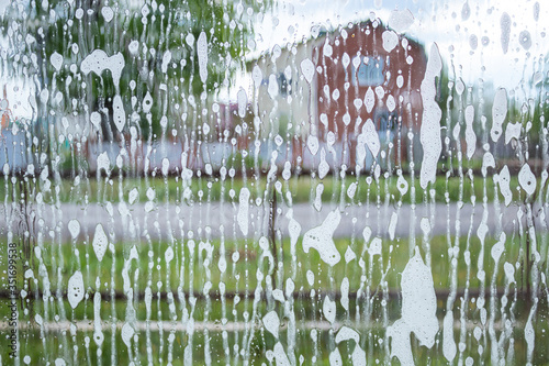 A soapy window that is going to be washed. Window with foam particles. Excellent texture