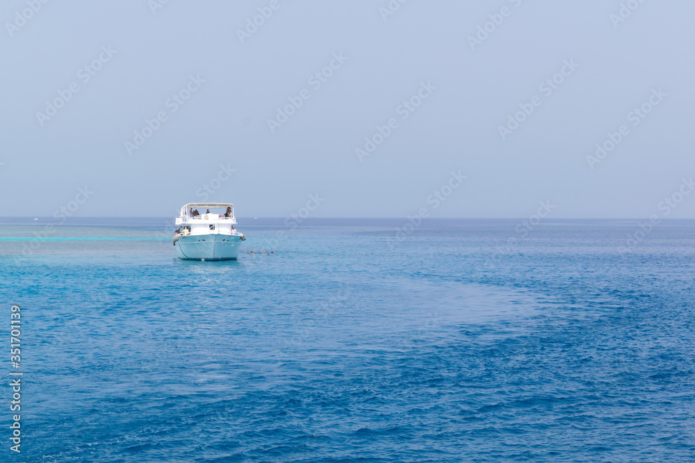 Boat yachting in the blue sea, landscape of ship in calm open ocean Boat yachting in the blue sea, landscape of ship in calm open ocean
