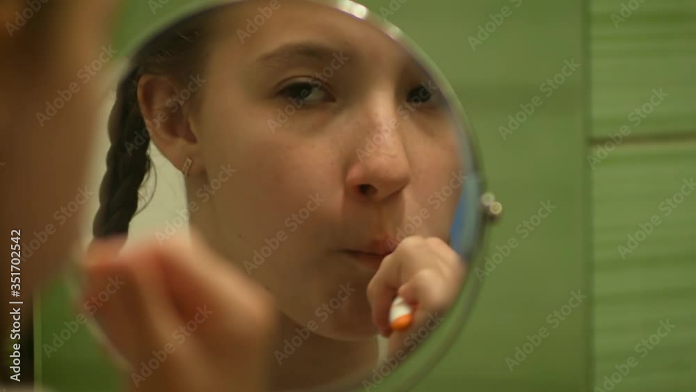 close up of a child brushing his teeth reflection in the mirror close up of a child brushing his teeth reflection in the mirror