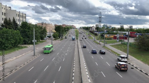 City highway before the rain. Highway under a dramatic sky with clouds. Cars under the cloudy sky.