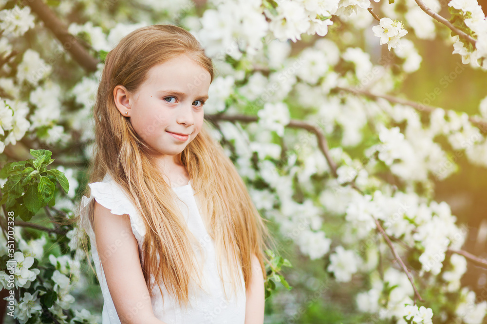 Beautiful preteen girl with long blond hair enjoy spring apple blooming. Little preschool girl in garden tree flowers. Copy space for text. Beautiful preteen girl with long blond hair enjoy spring apple blooming. Little preschool girl in garden tree flowers. Copy space for text.