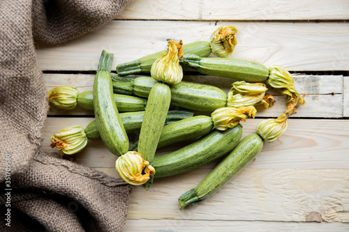 Fresh zucchini or green courgette, farm fresh produce, summer squash on a wooden table  photo