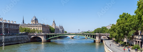 Panoramic view of the Tribunal de Commerce, the Conciergerie, Pont Notre Dame and Parisians walking on the embankment - Paris, France