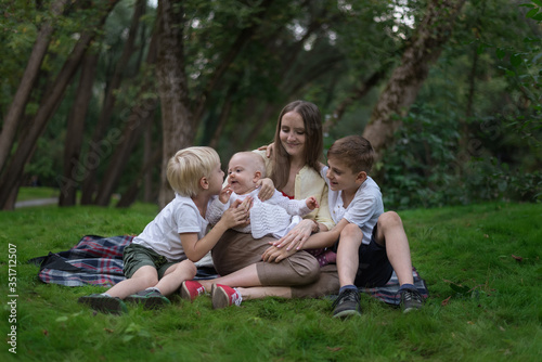 Three kids and amom in a park in clearing. Older siblings for my youngest sister © somemeans