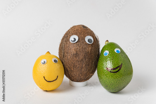 Lemon, coconut and avocado with funny faces. Different nationalities friendship