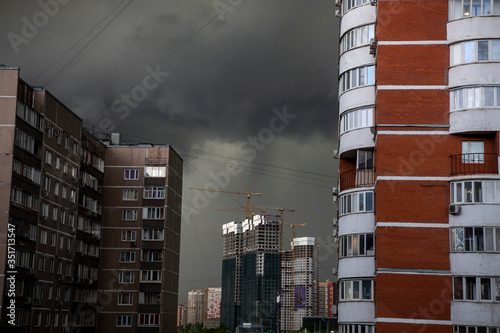 black rainy clouds in a residential area of ​​the city