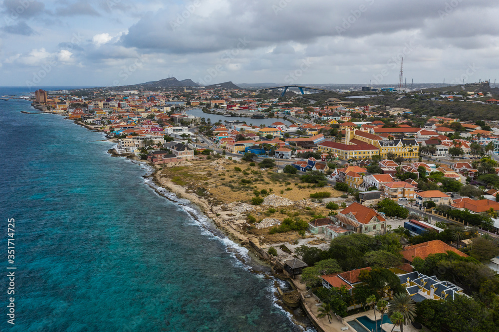 Aerial view of coast of Curacao in the Caribbean Sea with turquoise water, cliff, beach and beautiful coral reef 
