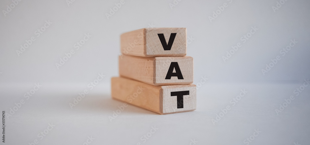 inscription vat on wooden cubes on white background inscription vat on wooden cubes on white background