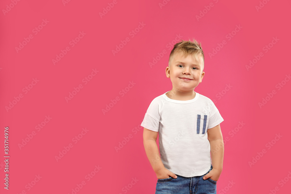 Cute little boy posing on pink background. Space for text Cute little boy posing on pink background. Space for text