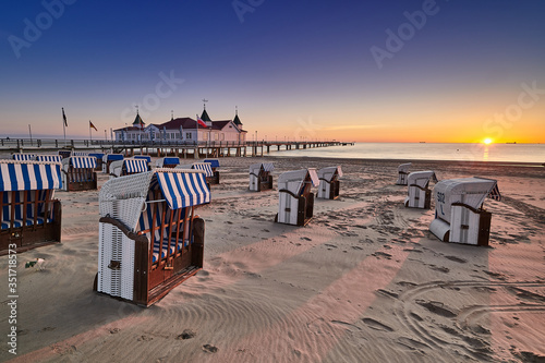 Fototapeta Naklejka Na Ścianę i Meble -  morning time at baltic sea beach and sight Ahlbeck pier in sunrise