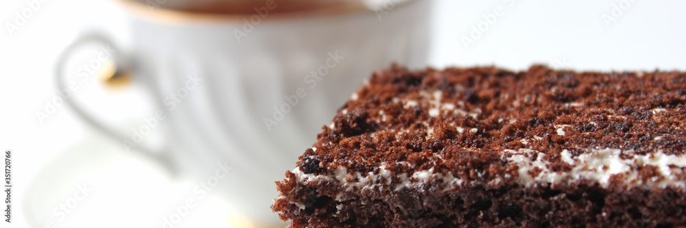 Banner. Homemade chocolate brownies with cup of tea on white background, selective focus