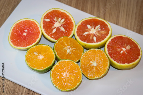 Beautiful lemons and grapefruits cut in half on a cutting board.