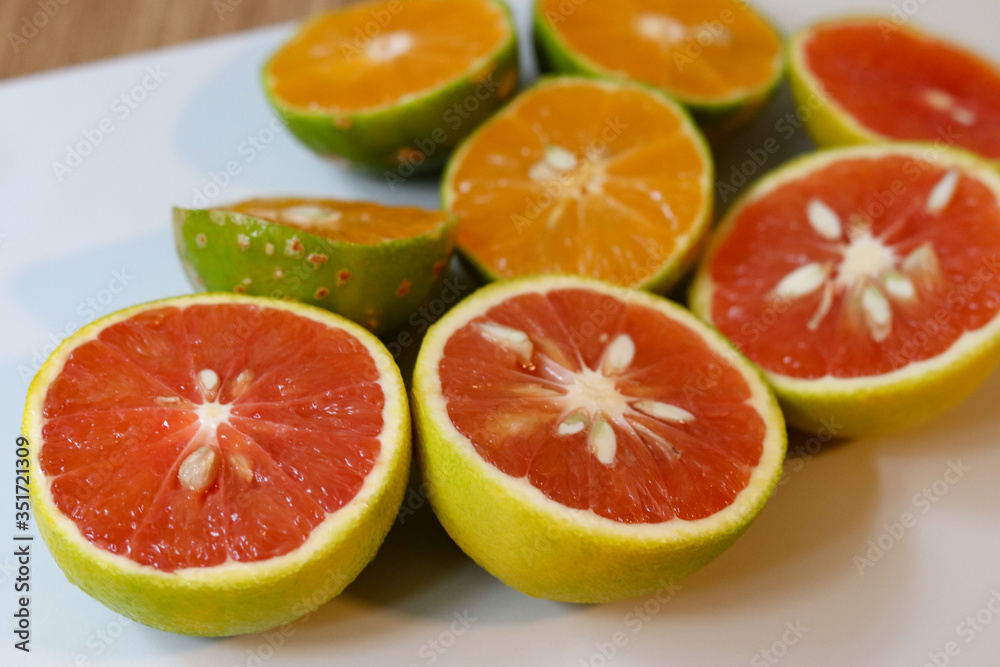 Beautiful lemons and grapefruits cut in half on a cutting board. Beautiful lemons and grapefruits cut in half on a cutting board.