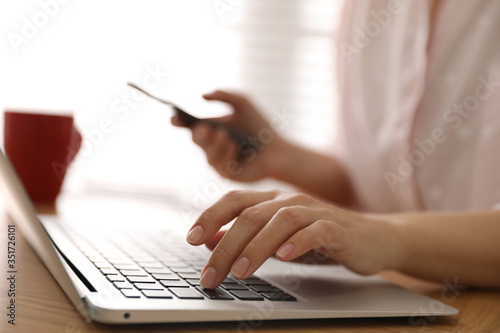 Woman working with laptop in office, closeup