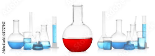 Florence flask with red liquid near laboratory glassware on white background. Banner design