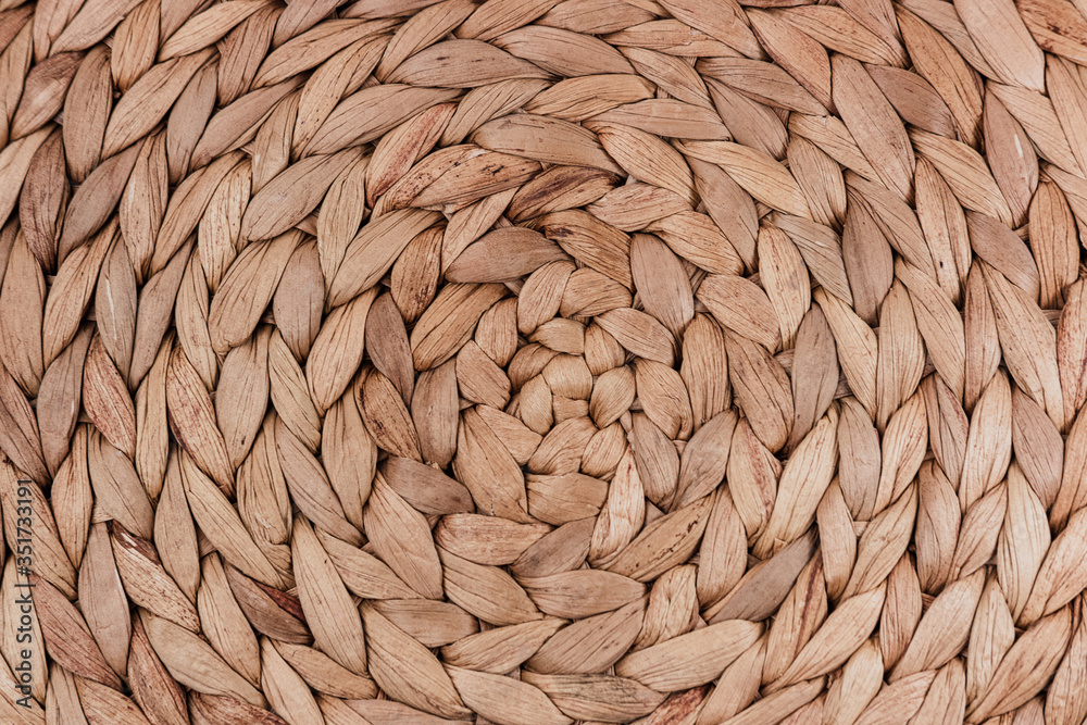 Beige natural mat of dry wicker grass as texture, background Beige natural mat of dry wicker grass as texture, background