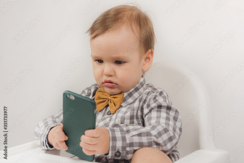 Little boy looking at the phone
