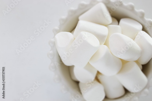 Marshmallow In bowl on white background with copy space